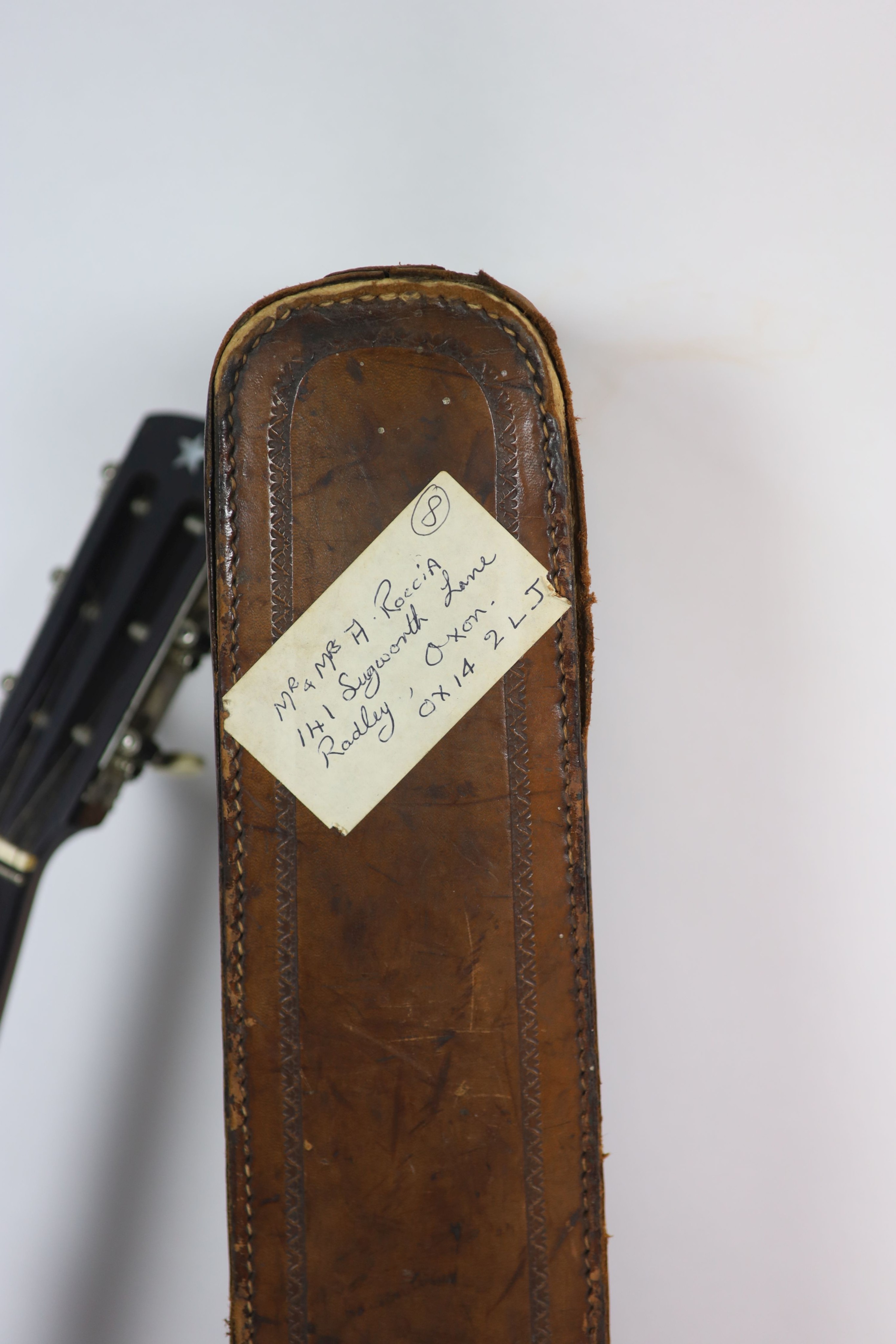 A Clifford Essex ebony mounted banjo, length 94cm, with distressed leather case